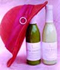 Picture of Oscar's Basil Dressing and Romano Dressing in bottles adjacent Oscar's red hat. Linked